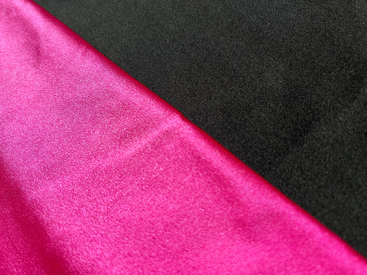 Flat surface of black and pink shiny fabric